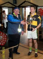 Captain Conal McLarnon accepts the P. Keeley Trophy