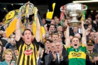 Kilkenny captain Michael Fennelly raises the Mc Carthy Cup while Kerry Captain Darren O'Sullivan holds aloft the Sam Maguire